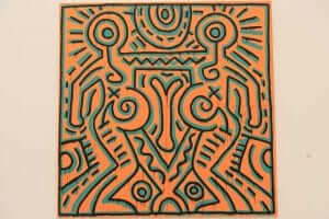 An orange and blue painting on a wall.