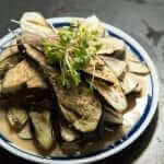 A plate of eggplant with a sauce on it.