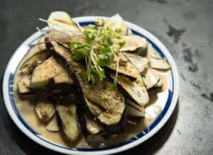 A plate of eggplant with a sauce on it.