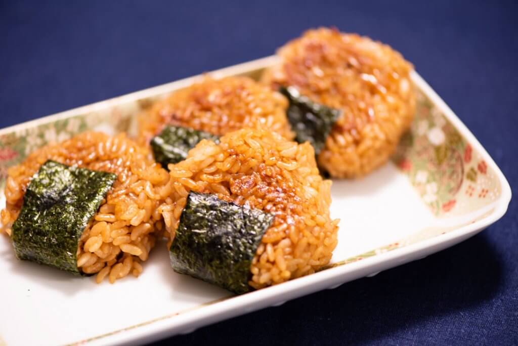 yakionigiri - grilled rice balls with soy sauce and nori on plate