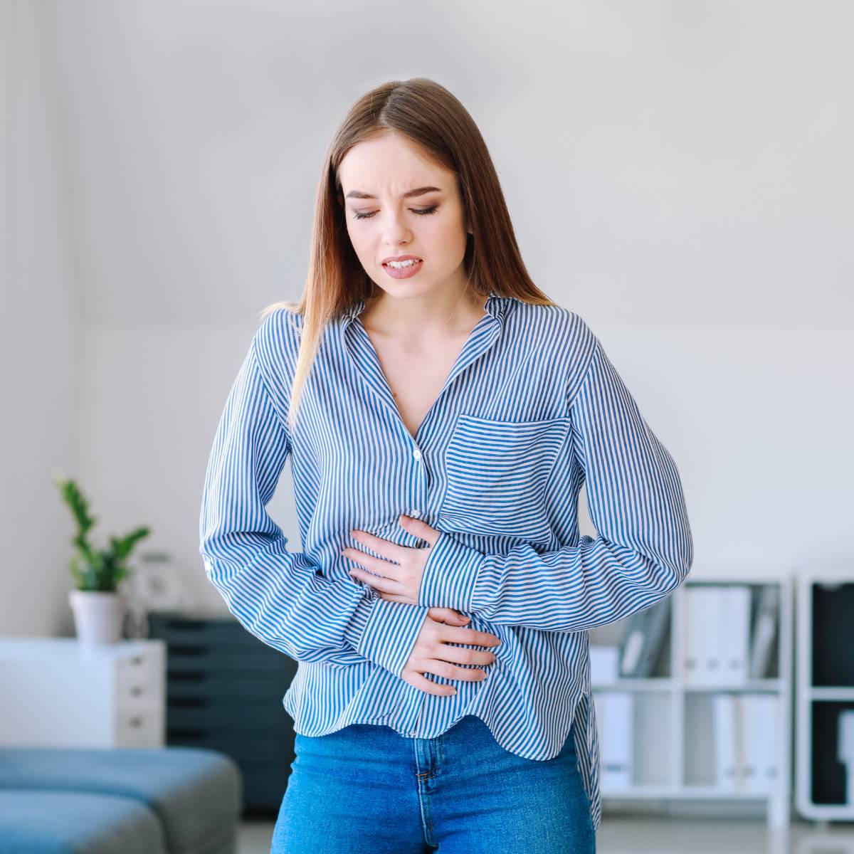 Woman in blue clothing having a bowel movement