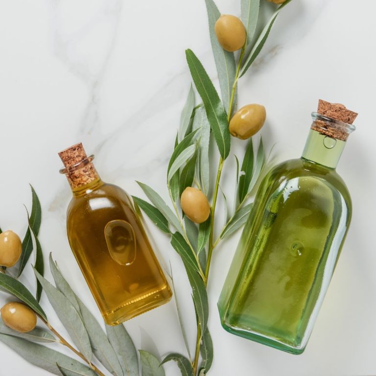 Refined olive oil and extra olive oil sits on the table.