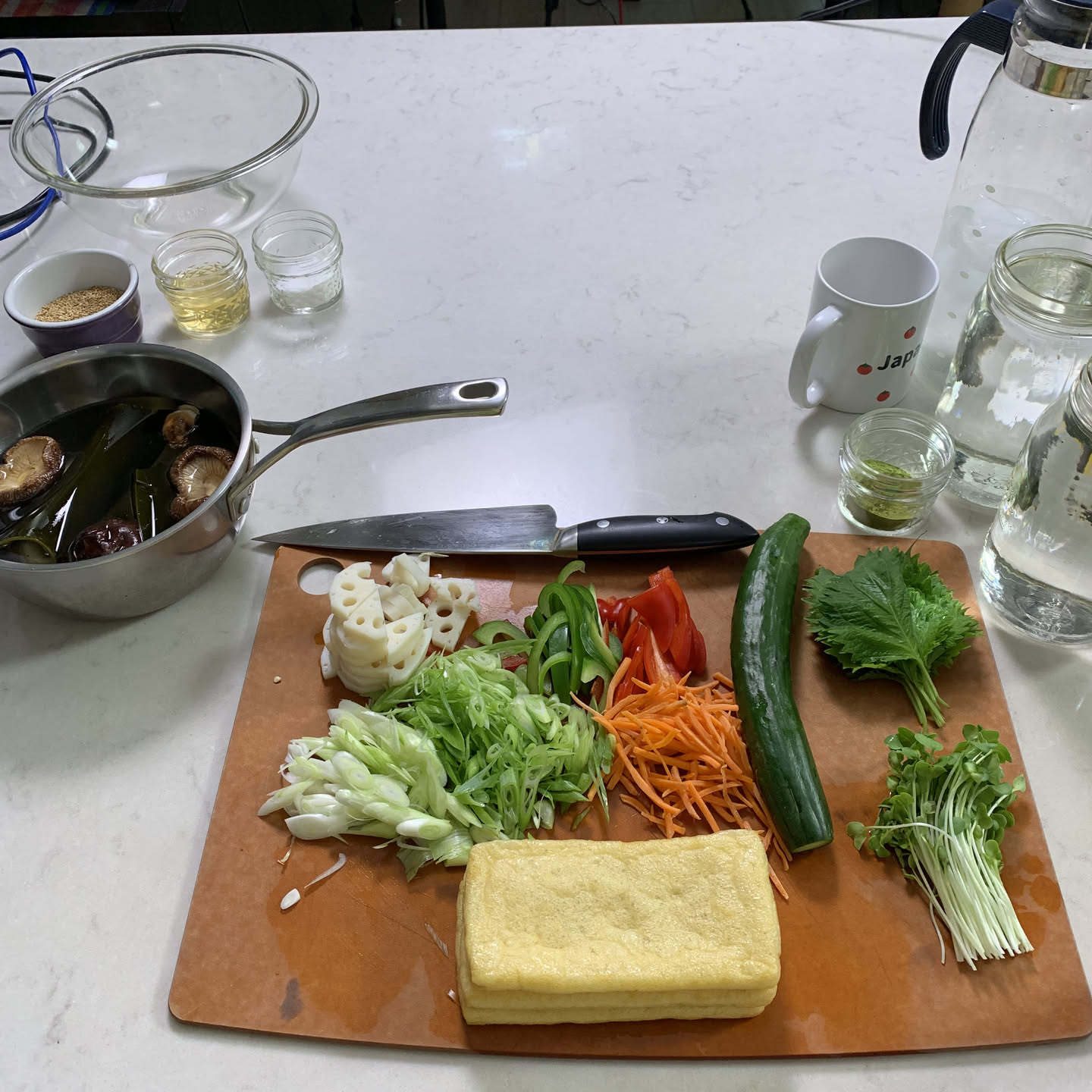 Sharp Japanese knife with prepped vegetables on a cutting board