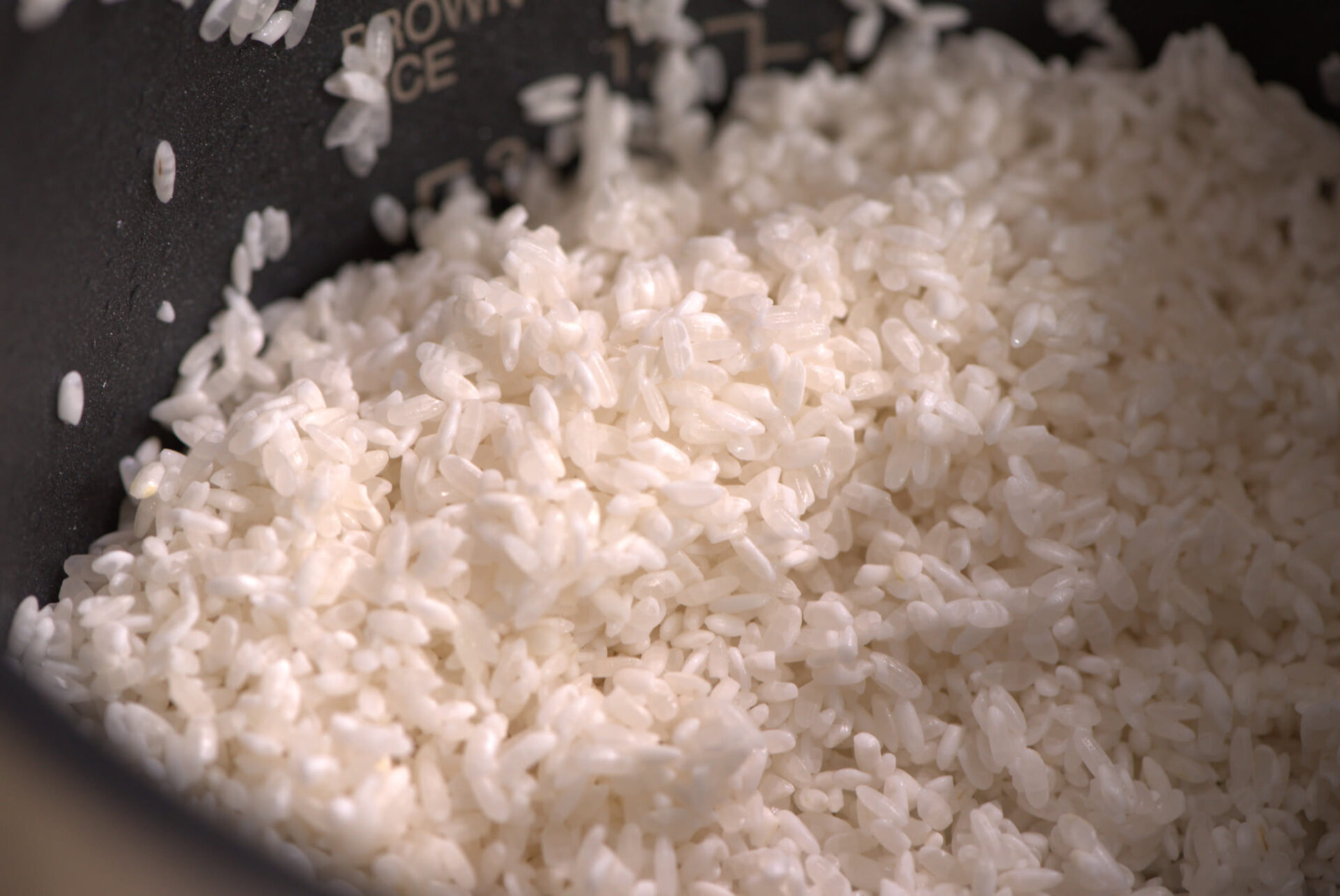 Cooked white rice inside a rice cooker inner pot
